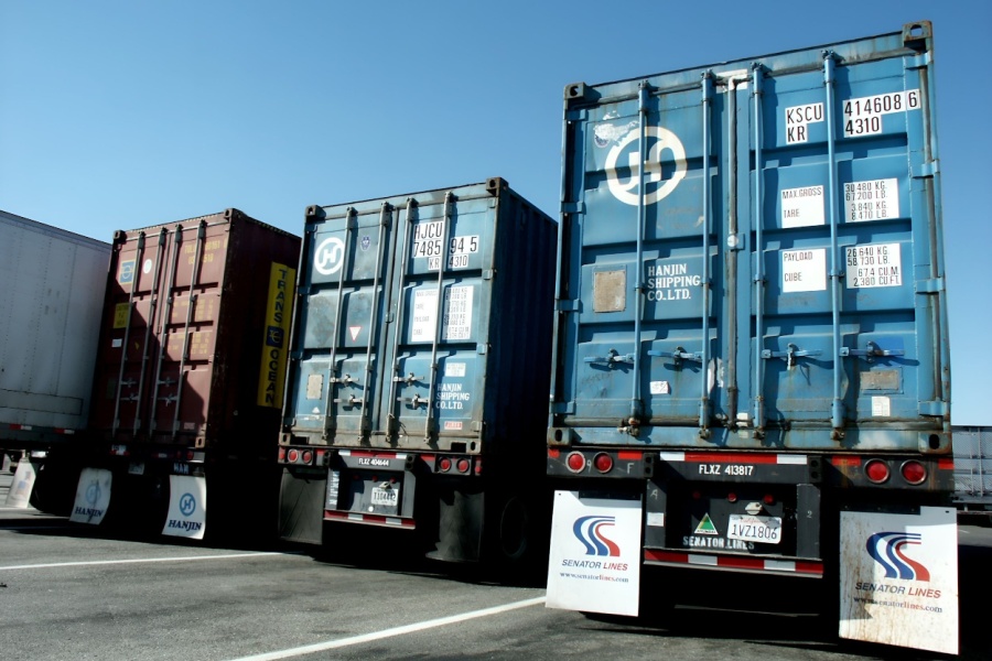 Commercial trucks and trailers at a truck stop.