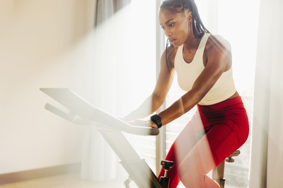 Woman taking an indoor cycling class