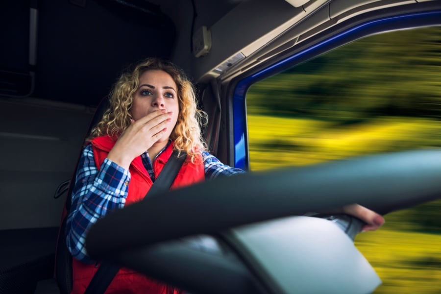 Truck driver in the cab of a vehicle