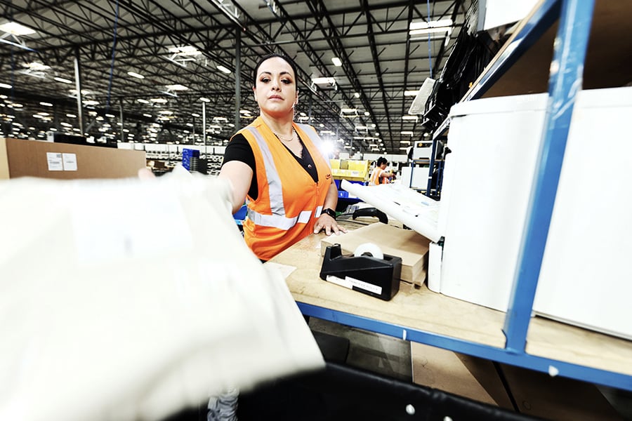 Employee sorting packages at an e-commerce fulfillment center