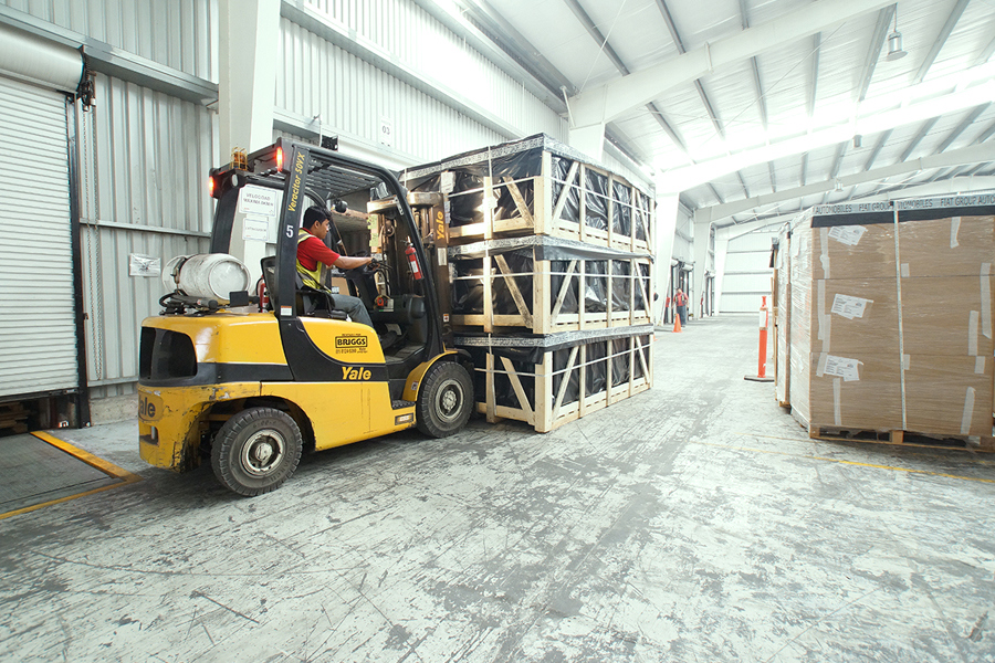 forklift moving pallets in nearshoring warehouse