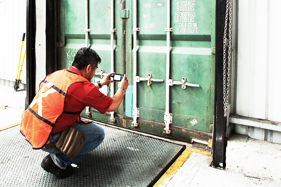 employee securing shipping container for nearshoring client
