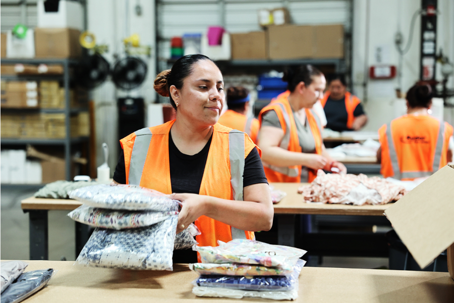 3PL fulfillment center worker packing customer order