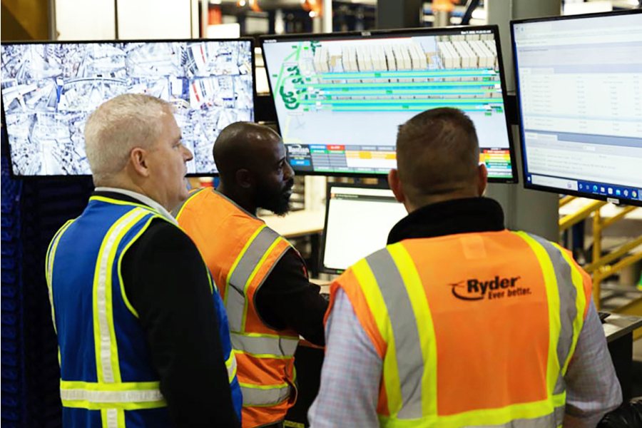 retail fulfillment workers tracking a shipment on computer screens