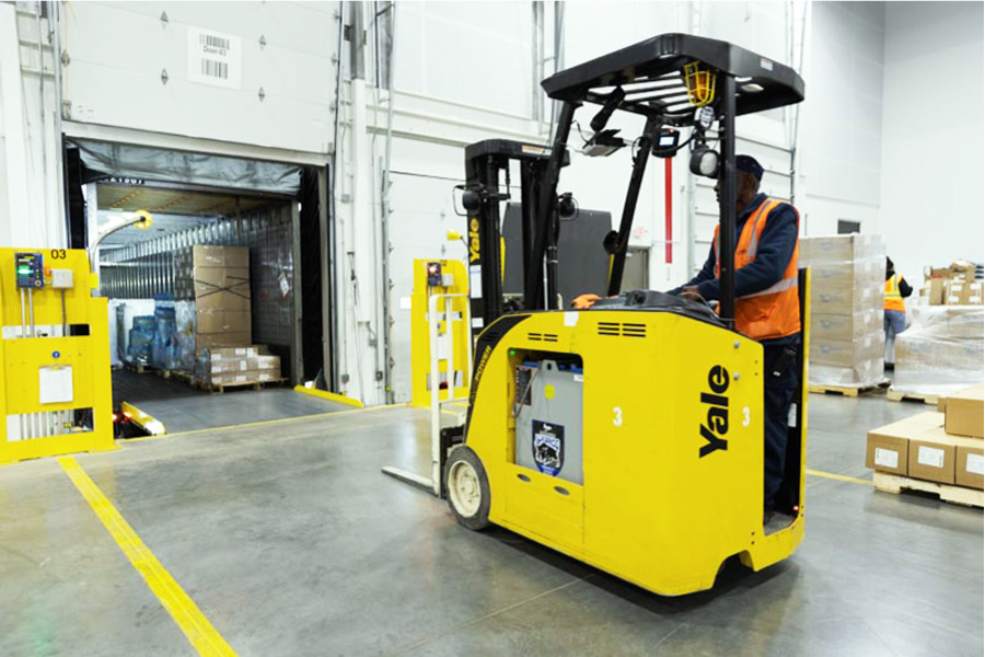 warehouse worker on yellow forklift