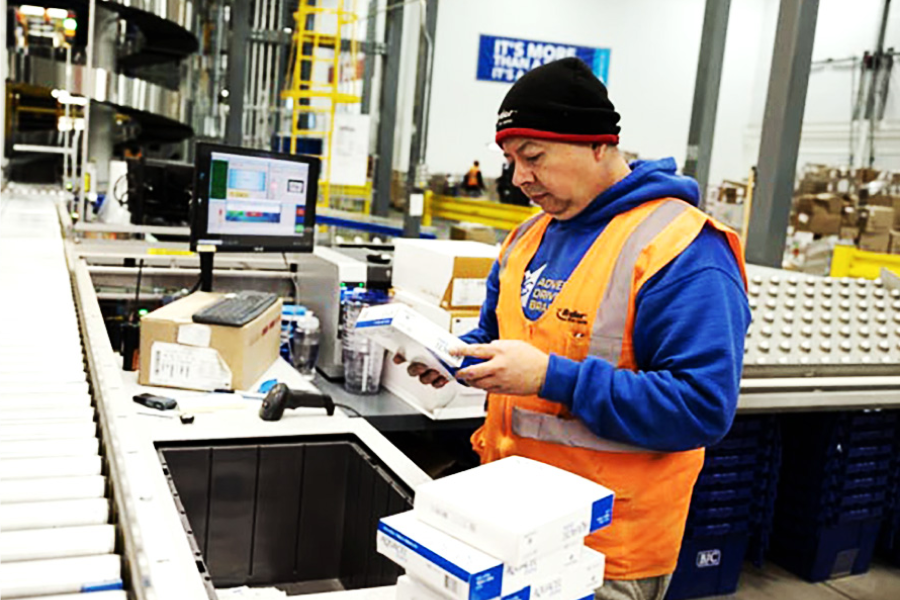 warehouse worker checking packages for quality control